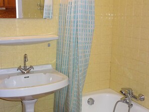 A bathroom with a sink, a shower, and a bathtub.