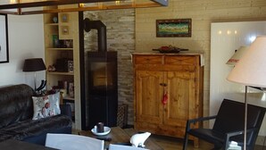 Un salon chaleureux avec une cheminée, des meubles en bois et un coin repas.