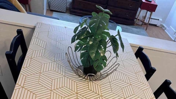 A dining table with a geometric patterned tablecloth, surrounded by black chairs. - Central Location, Cozy, and Well-Equipped (Halifax)