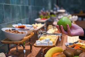 A buffet with various food items including fruits, cheeses, and other snacks. - Landmark Hotel (Batumi)