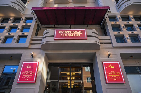 The exterior of a hotel with a prominent sign reading "Landmark Hotel" and a smaller sign below stating "Batumi Haidar Abbasidze 26". - Landmark Hotel (Batumi)