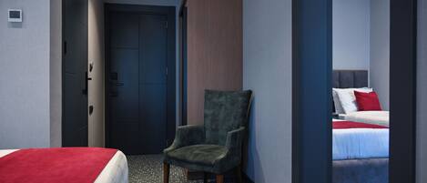A hotel room with a bed, a chair, a door, and a wall with a vertical panel.