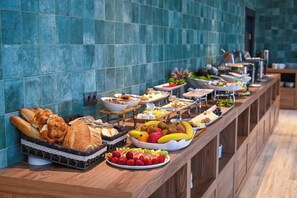 A buffet with various food items including bread, fruits, and vegetables. - Landmark Hotel (Batumi)