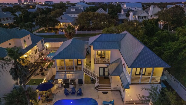 A large house with a swimming pool, multiple decks, and outdoor lighting. - Lighthouse Legends-Free Golf Cart-1 Block to Beach (Destin)