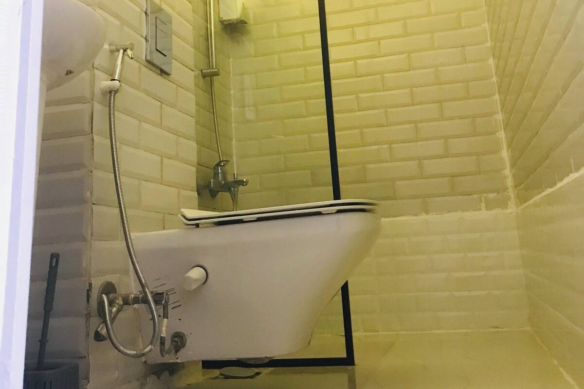 A bathroom with a white sink, a mirror, and a shower.