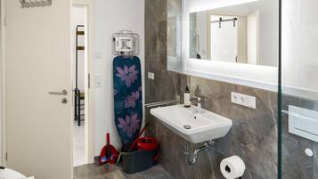 Shower, rainfall showerhead, hair dryer, towels