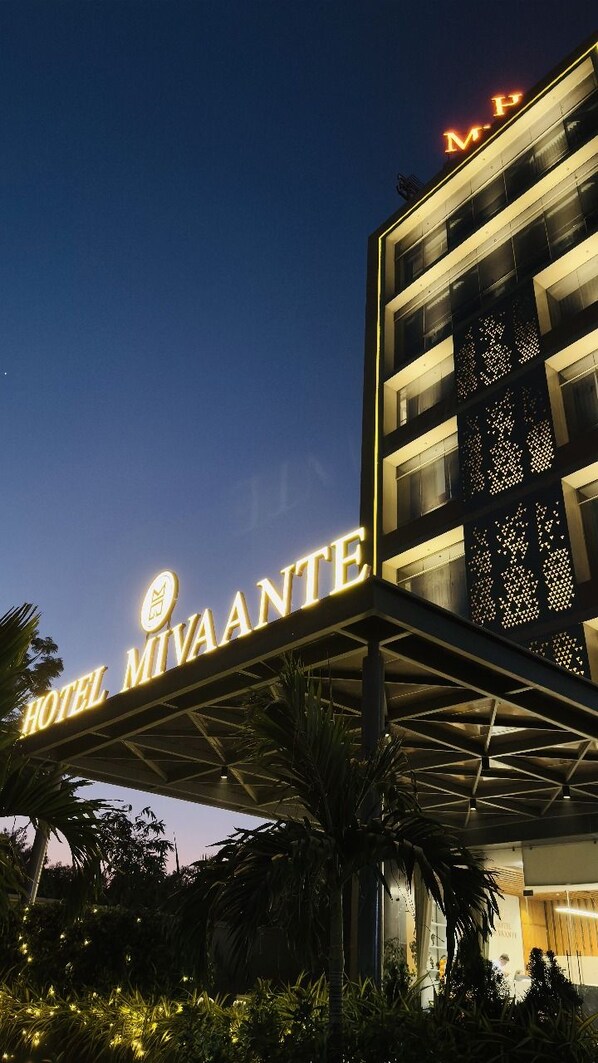 The exterior of Hotel Mivaante with illuminated signage and a modern architectural design. - Hotel Mivaante (Ahmedabad)
