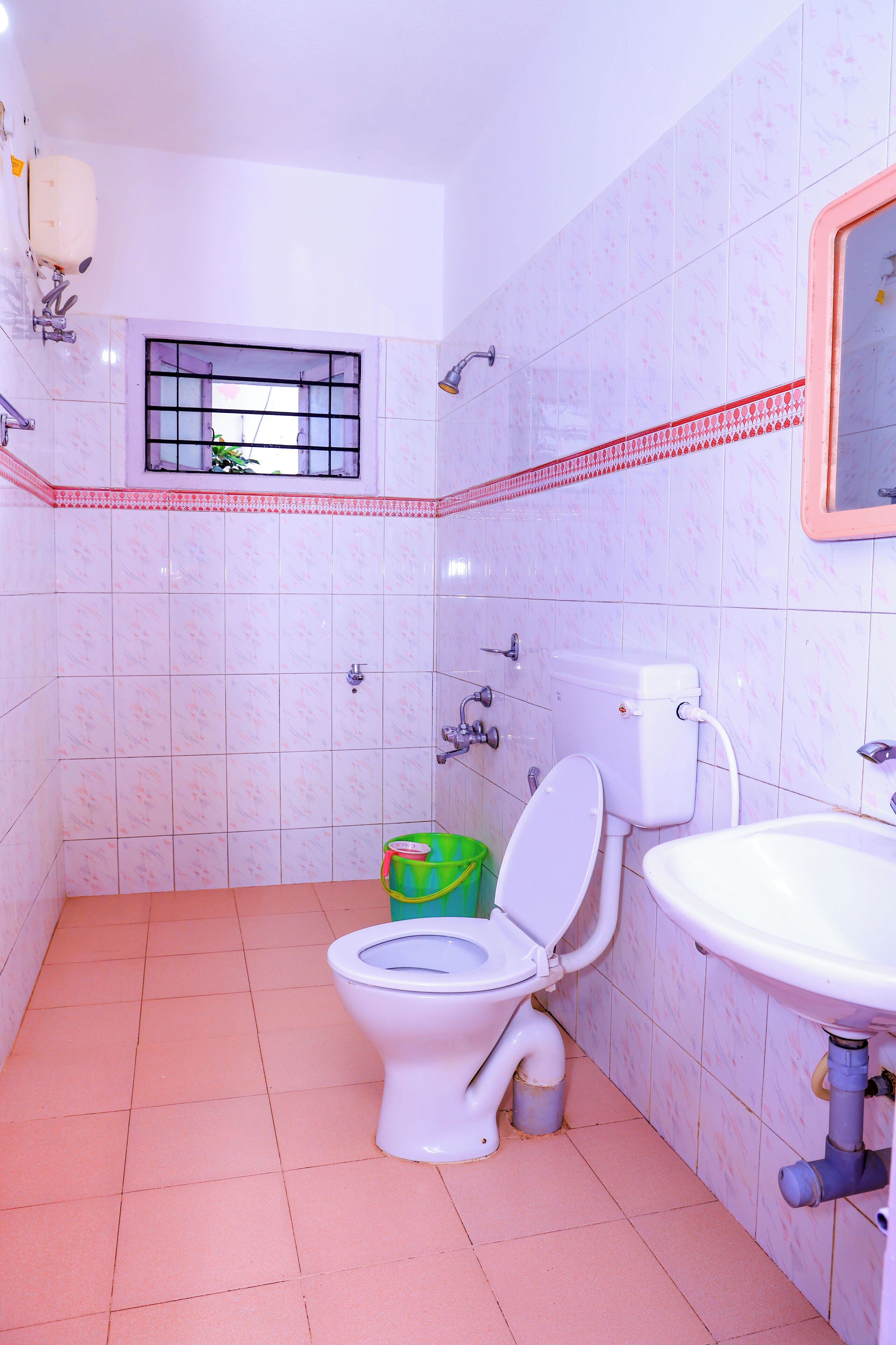 A bathroom with a toilet, sink, and shower.