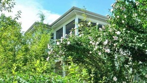 A building with a symmetrical facade, large windows, and a central entrance. - (3 Nt Summer Min!) Union Pier Condo With Heated Pool! July 04-10 OPEN! (Union Pier)