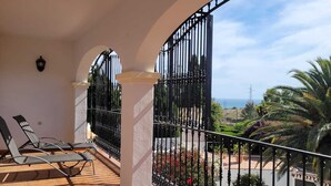 A balcony with a view of the sea, a tiled floor, and a metal railing. - Impressive villa with private pool & sea views on a finca (AN)