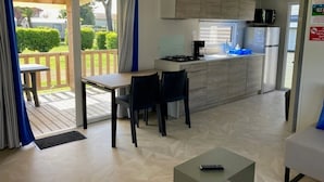 Une cuisine moderne avec un coin repas, une petite table et une vue sur l’extérieur.