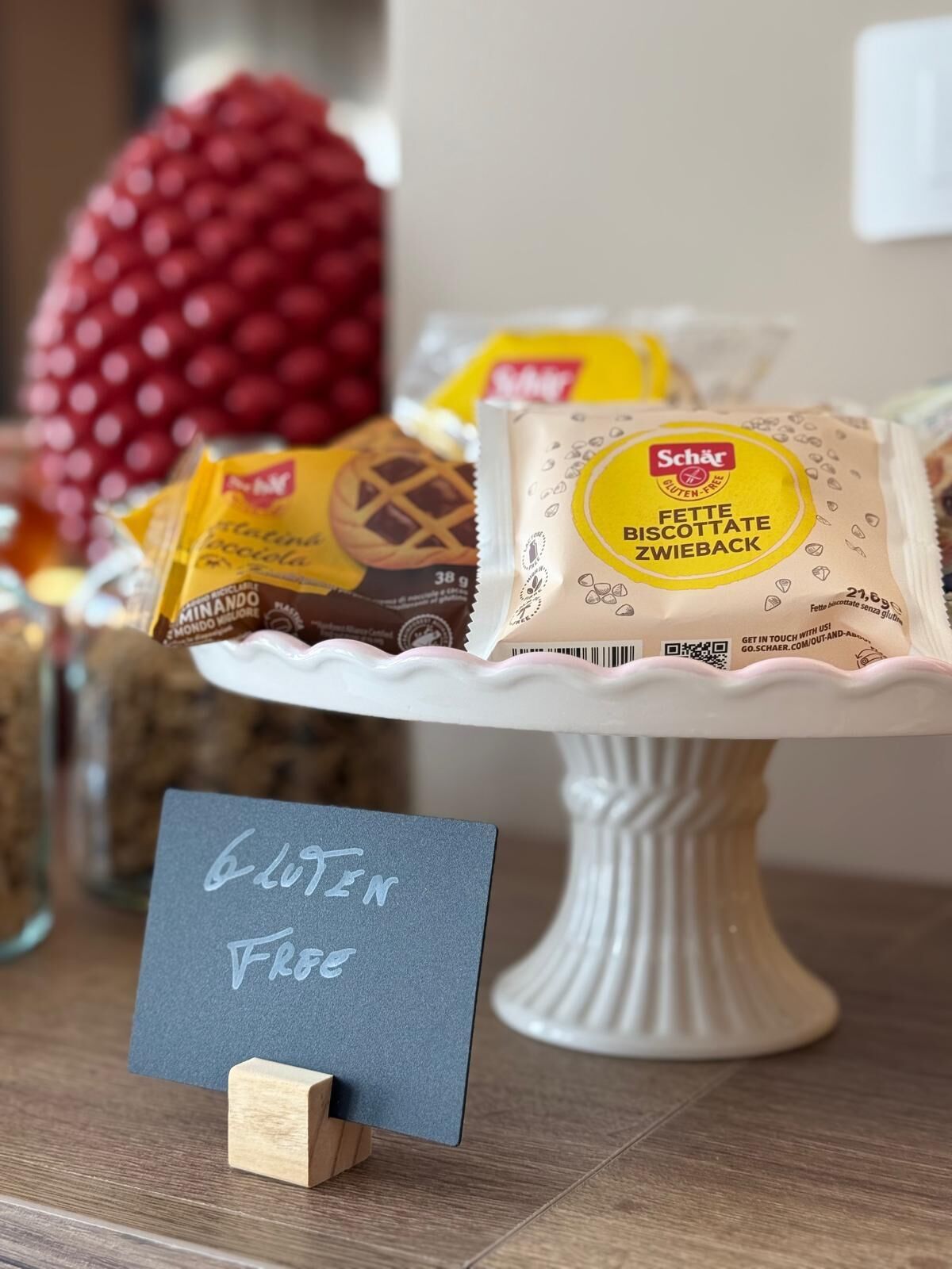 A dessert display with gluten-free options, including a sign indicating gluten-free products.