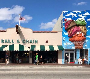 A storefront with a sign reading "BALL & CHAIN" and an American flag.