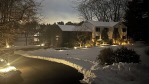 A snow-covered landscape with a house, a barn, and a pond. - 2BR, 2 King beds, 1 BA, and Kitchenette in Lakeside Home in Greenwich. (Greenwich)