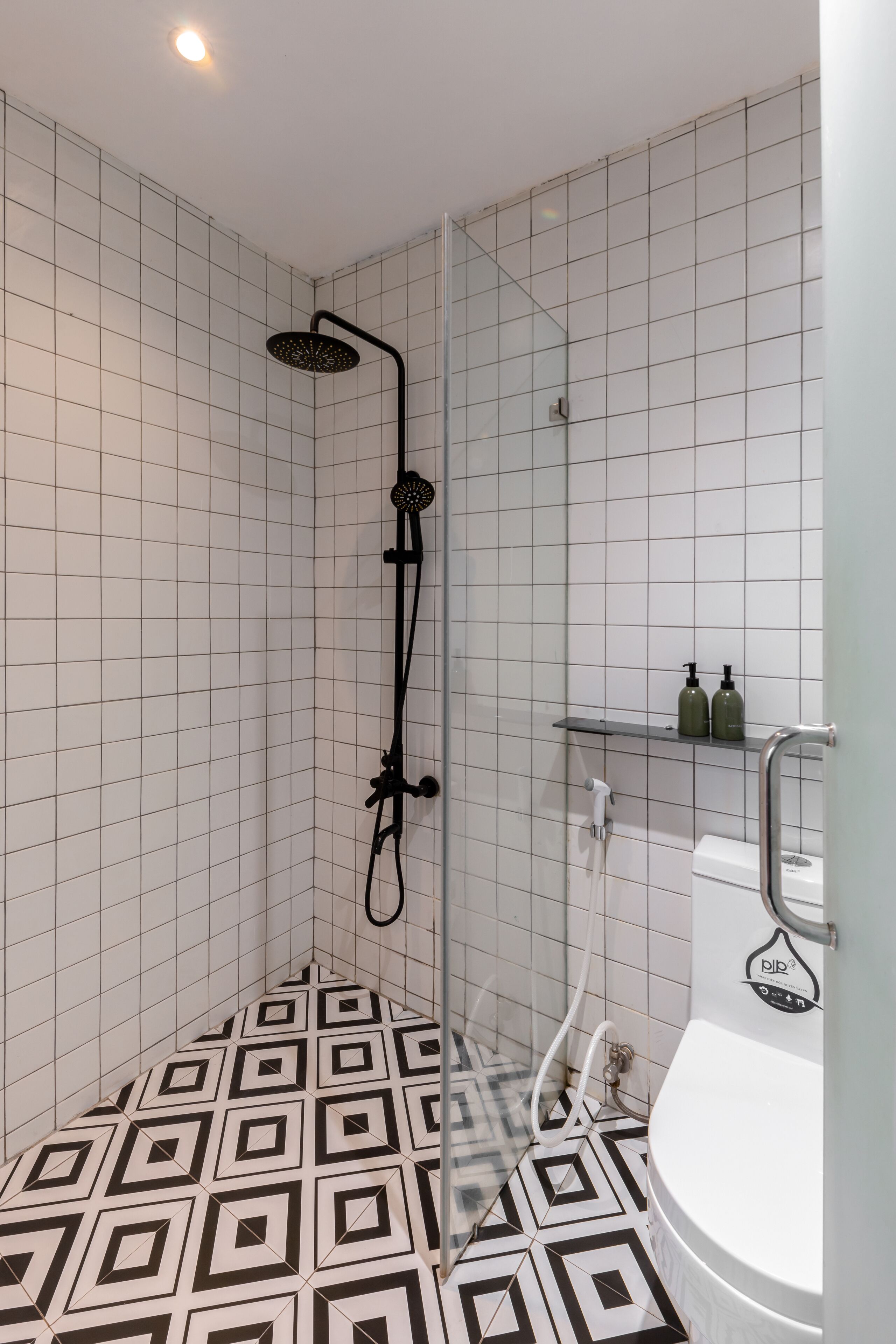 A bathroom with a shower, a toilet, and a sink.