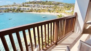A balcony with a view of the sea and buildings.