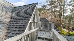 A wooden staircase leading up to a house with a dark shingled roof and a white fence. - Charming 1 BR Atlanta Retreat: Minutes to Midtown (Atlanta)