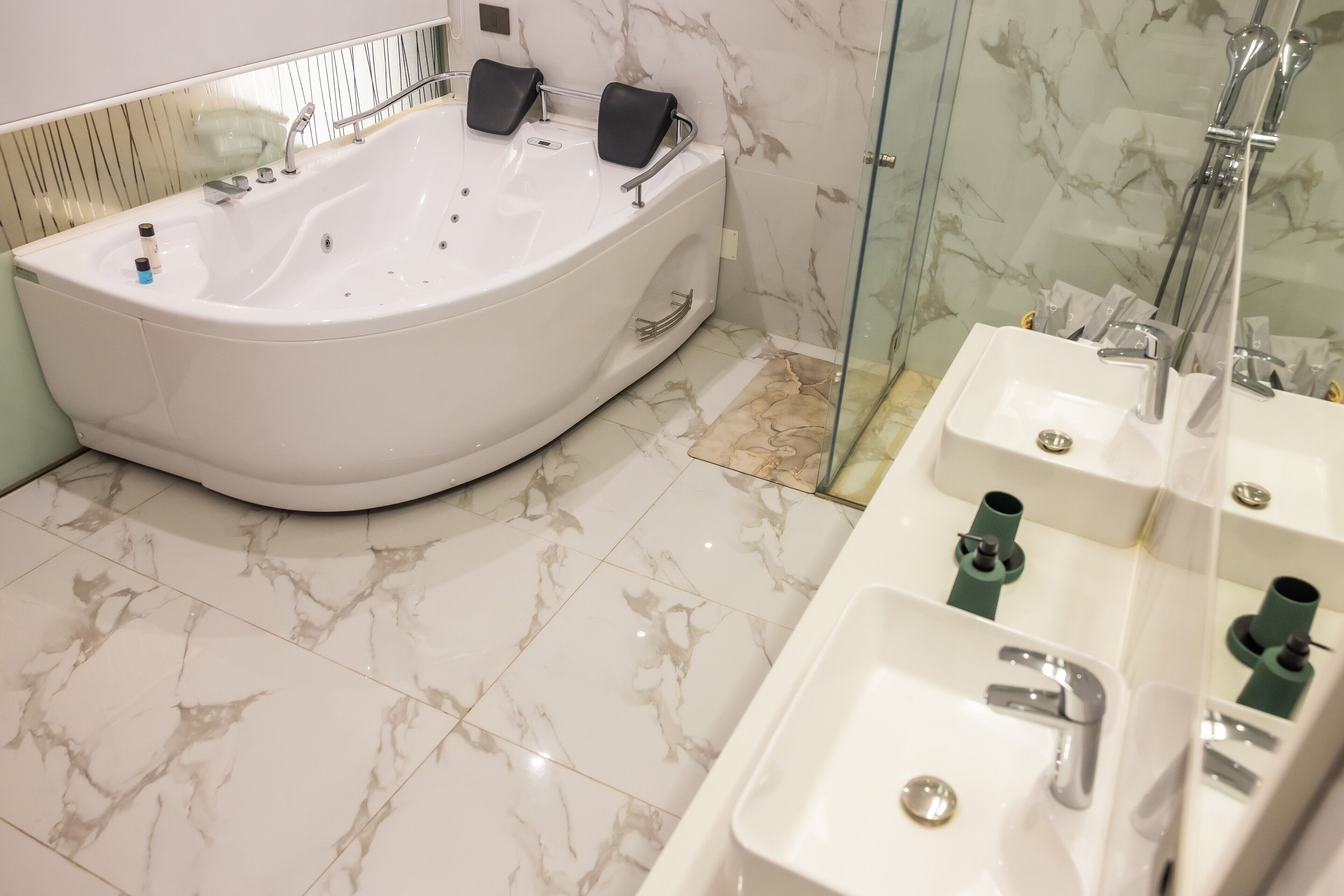 A modern bathroom with a freestanding bathtub, a glass-enclosed shower, and a vanity with a sink.