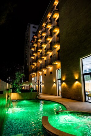 A hotel with a swimming pool, outdoor lighting, and a building facade with balconies. - Le Grove Hotel (Jounieh)