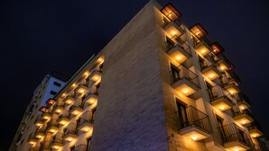 A multi-story hotel with balconies and illuminated windows at night. - Le Grove Hotel (Jounieh)