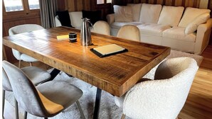 A wooden dining table with chairs, a coffee pot, and a notebook. - Swiss mountain chalet, wooden interior, cosy, with a beautiful view (Evolène)