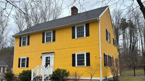 A two-story yellow house with black shutters, a white front door, and a small porch with steps. - Large 3-bedroom house in a quiet neighborhood in the village of Canton, NY (Canton)