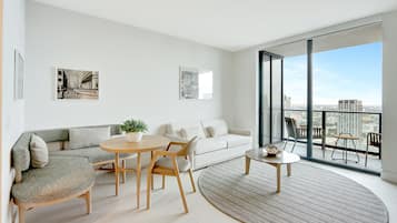 Executive Condo, City View | Living area | 65-inch Smart TV with satellite channels