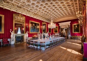 A grand dining room with a long table, ornate ceiling, and classical decor. - Stunning Cosy Rustic Farmhouse Alton Towers Peaks (Leek)