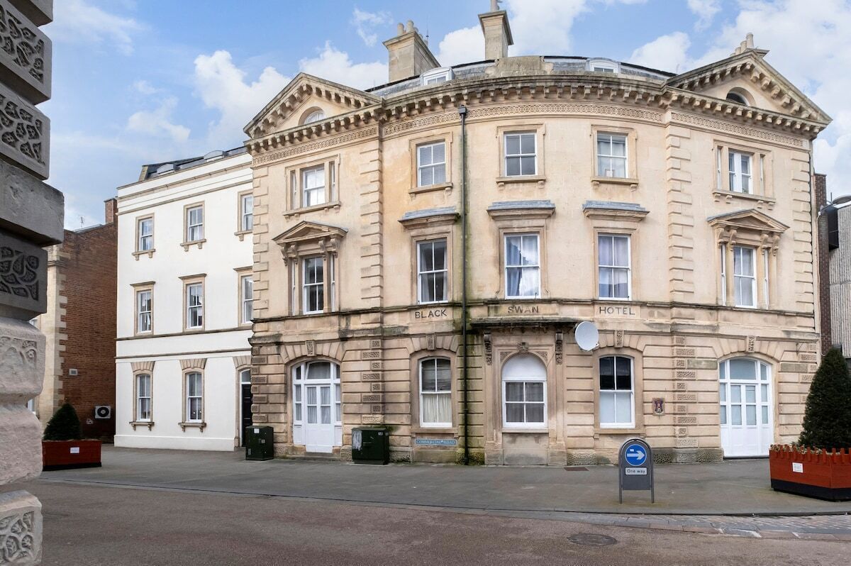 A historic building with a classic architectural style, featuring multiple windows and a prominent entrance.