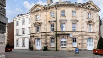 A historic building with a classic architectural style, featuring multiple windows and a prominent entrance.