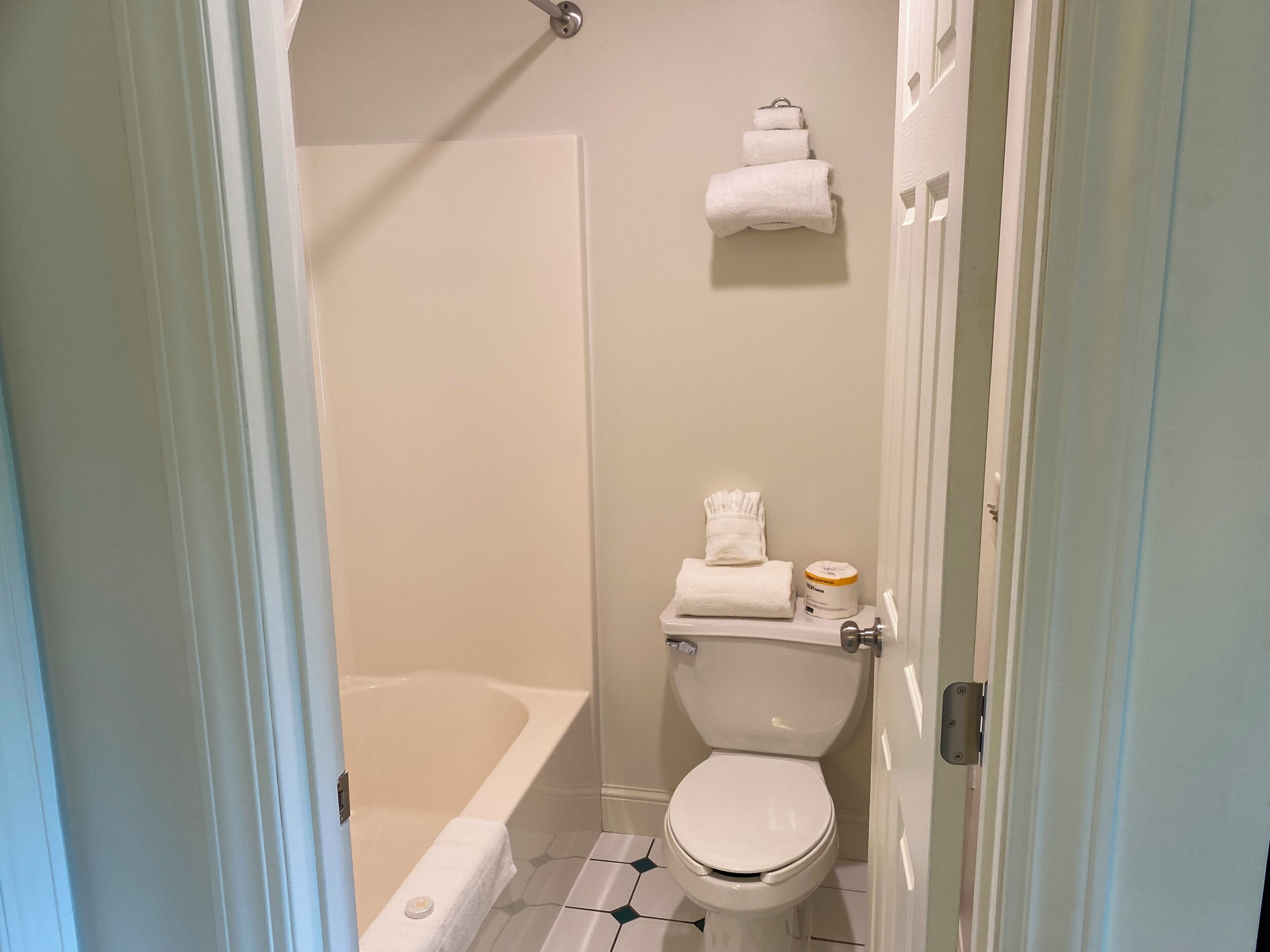 A bathroom with a toilet, a bathtub, and a shower.