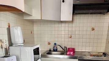 Een microgolfoven, een koffiezetapparaat/waterkoker, een kinderstoel