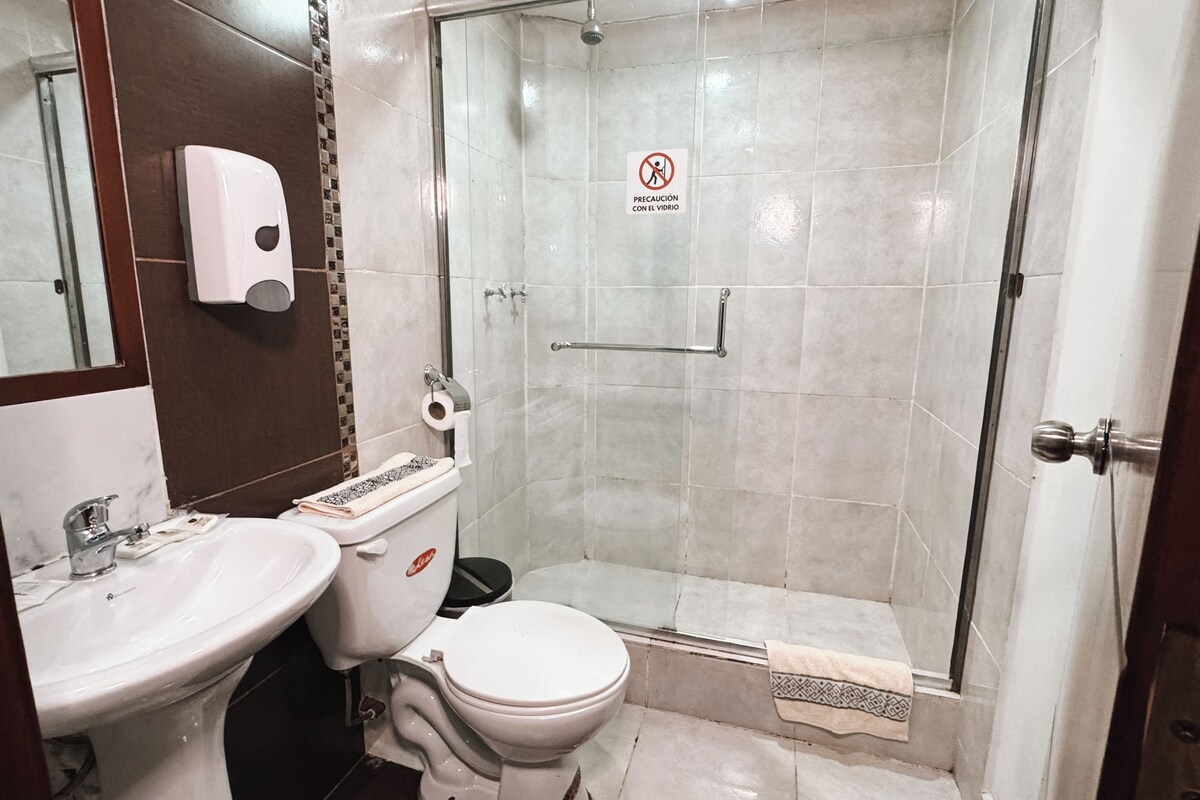 A bathroom with a sink, toilet, and shower.