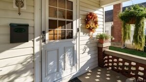 A white door with a window, a mailbox, and a hanging wreath. - Large 3 Bedroom, 2 Bath Home, Premium Kitchen, Large Family & Living Rooms (Dayton)