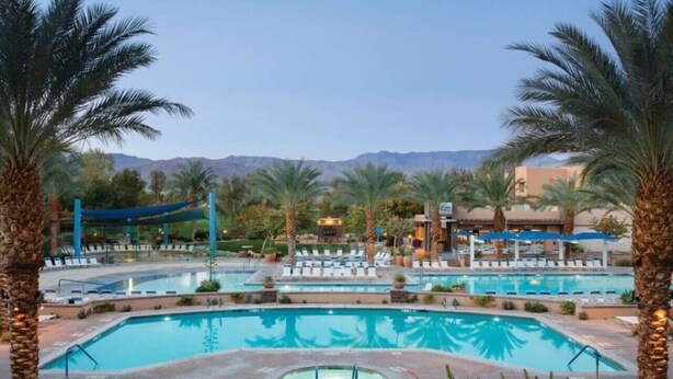 A pool area with multiple pools, palm trees, and a mountainous backdrop. - Awesome Marriott property with many amenities. Sleeps 8. Near Coachella! (Palm Desert)