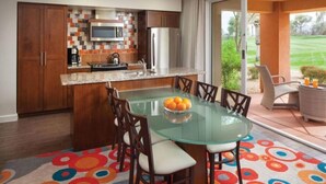 A modern kitchen with a glass dining table and chairs, a microwave, and a refrigerator. - Awesome Marriott property with many amenities. Sleeps 8. Near Coachella! (Palm Desert)
