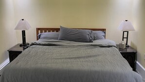 A bedroom with a bed, two bedside tables, a ceiling fan, and two lamps. - 3-bedroom house in tranquil Harvey with WiFi, AC. Relax and unwind (Harvey)