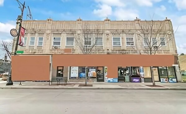 A two-story building with a flat roof and large windows.