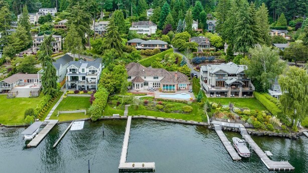 An aerial view of a residential area with houses, a dock, and a body of water. - Stunning Waterfront Mansion w Pool n Hottub (Mercer Island)