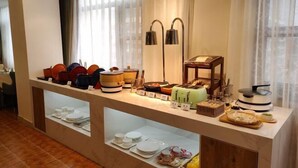 A buffet setup with various dishes and utensils, a coffee machine, and a tea station. - GreenTree Hotel (Beijing Xueqing Road Xuezhi Garden Subway Station) (Beijing)