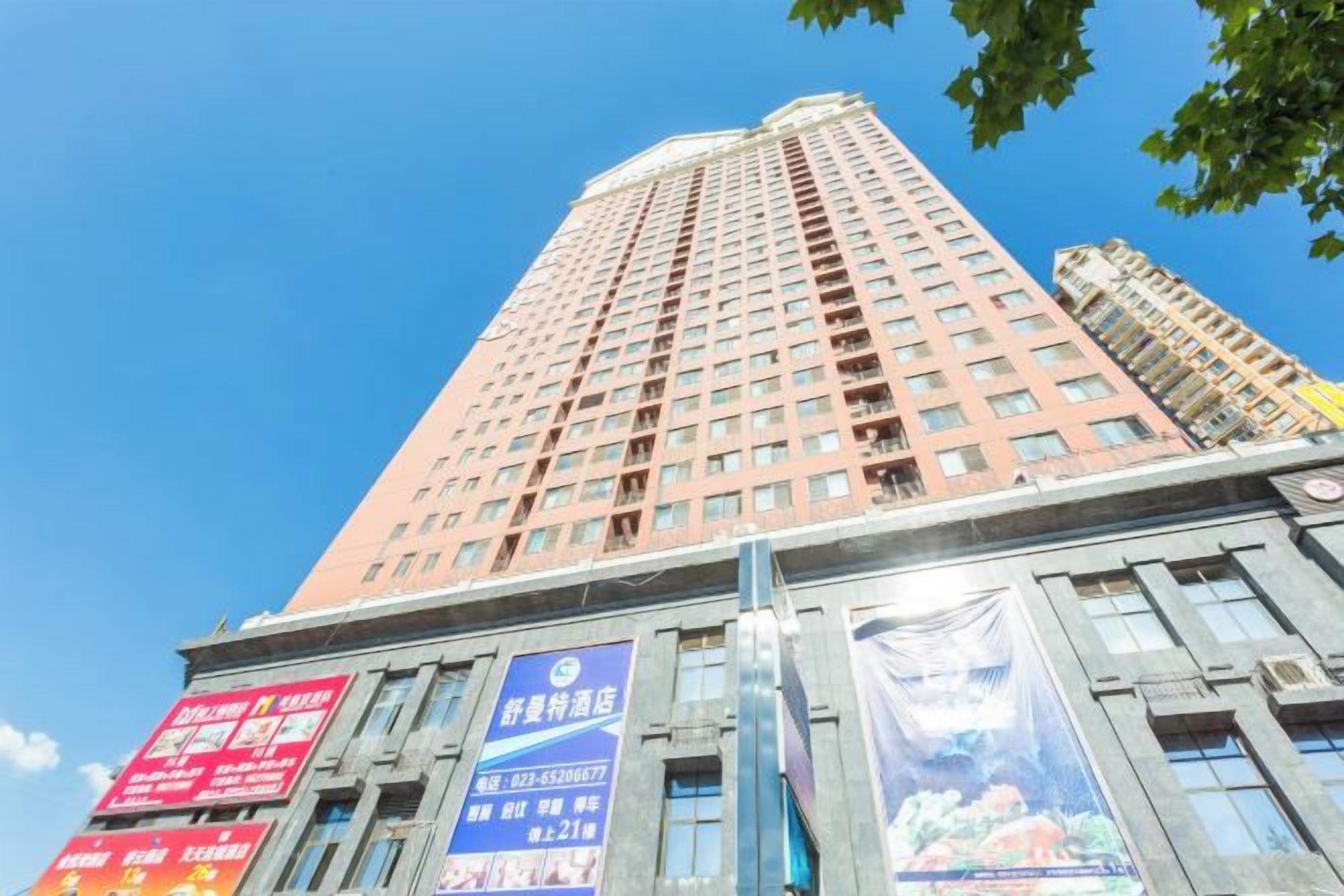 A tall building with multiple floors, large windows, and several banners.