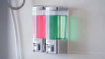 Two hand sanitizer dispensers mounted on a wall.