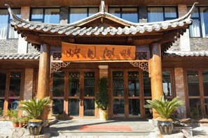 A traditional building with a tiled roof and a signboard. - Yingyue Lakeside Inn (Ninglang)
