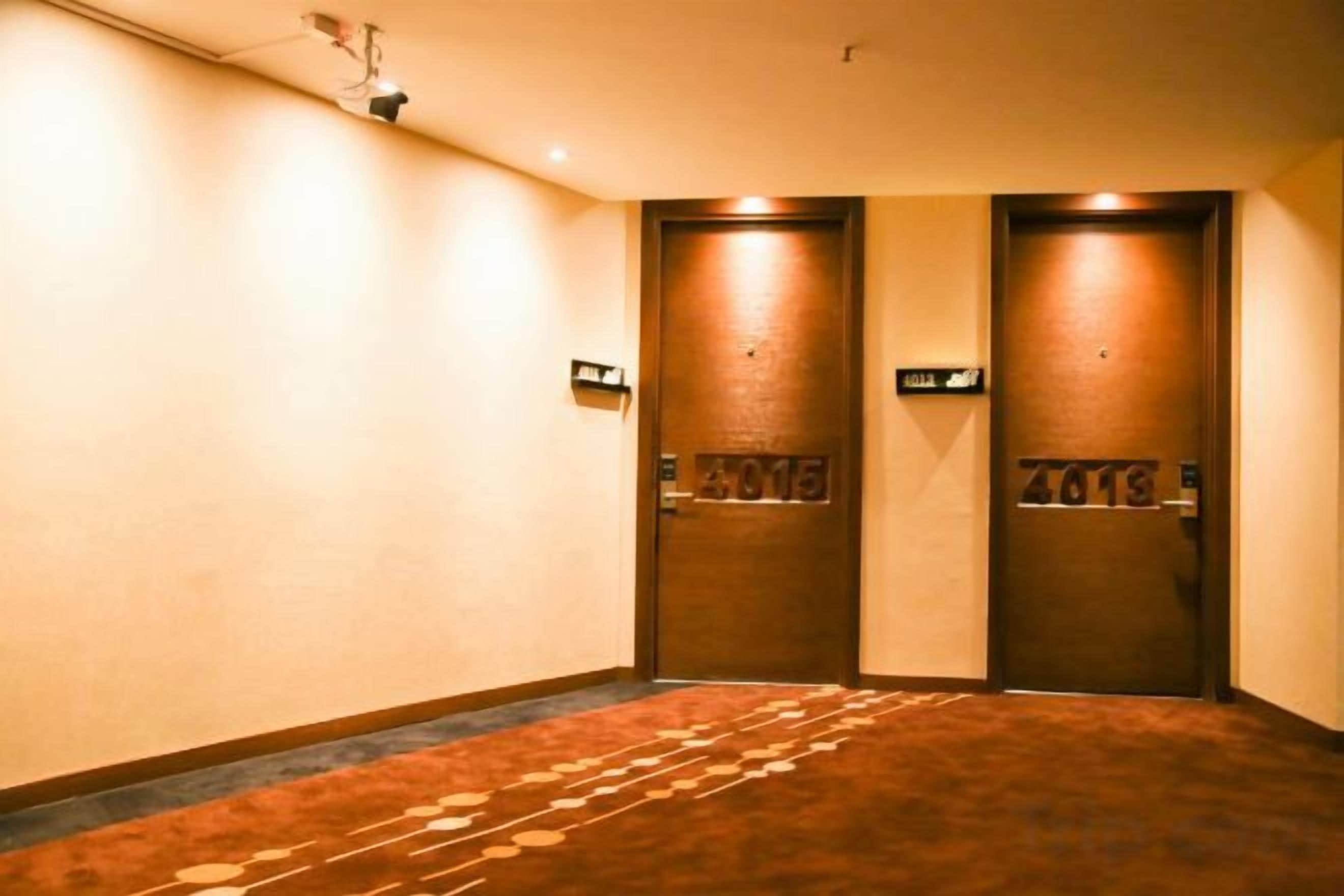 A hallway with two doors, each marked with a number.