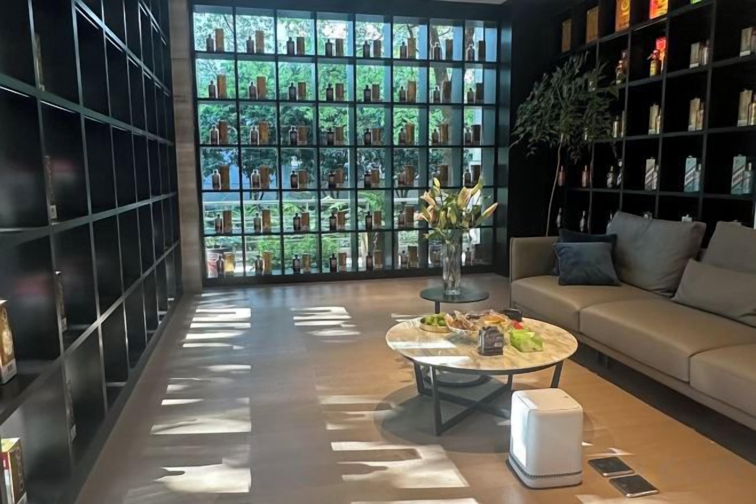 A modern interior with a sofa, coffee table, and a bookshelf.