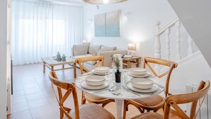 A dining area with a round table set for four, surrounded by wooden chairs. - Cofitsa Plus by Interhome (Jávea)