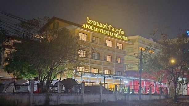 The Apollo Vientiane Hotel with a prominent illuminated sign, multiple windows, and a gated entrance. - Apollo Vientiane Hotel (Vientiane)