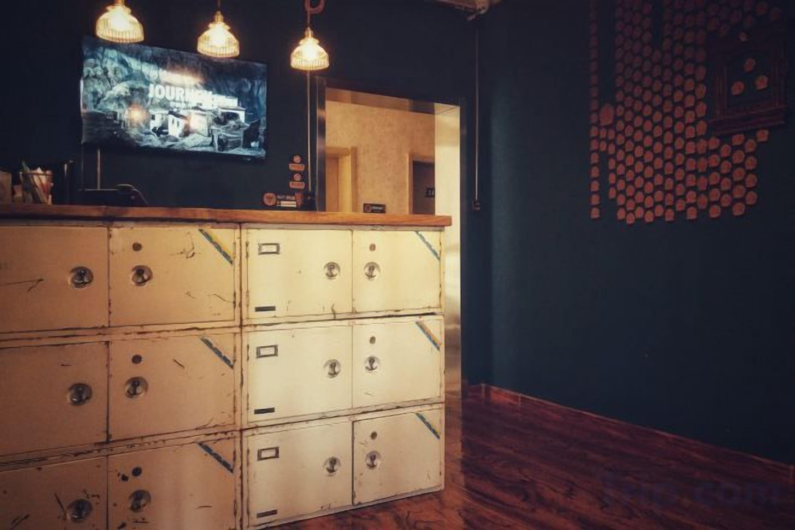 A bar area with a wooden counter and a television screen.