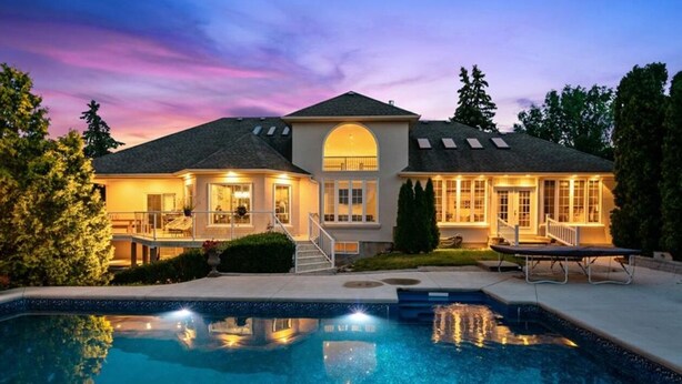 A two-story house with a swimming pool, large windows, and a well-lit exterior. - Charming 2 bedroom bed & breakfast in fabulous Niagara-on-the-Lake with pool (Niagara-on-the-Lake)