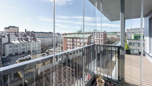 A modern building with large glass windows and a view of the cityscape. - Luxurious 1BR Penthouse with Balcony (Tampere)